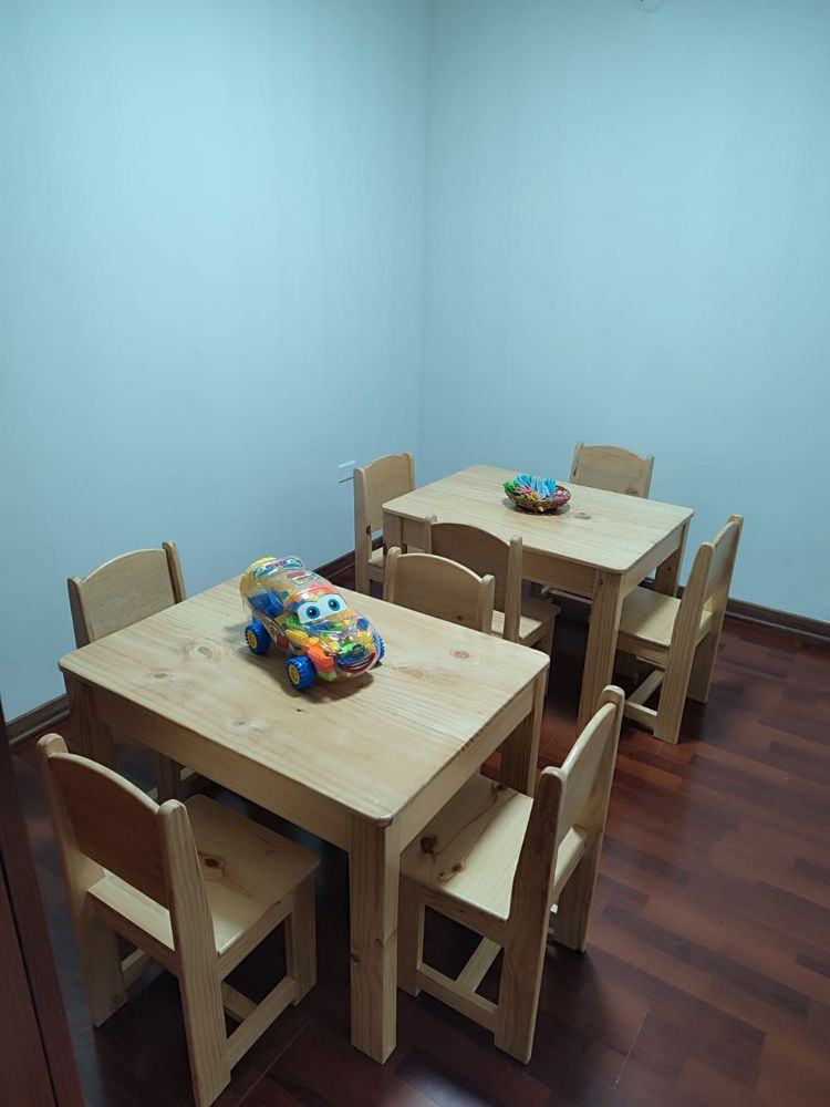 Aula con mesas y sillas de madera a la altura de los niños